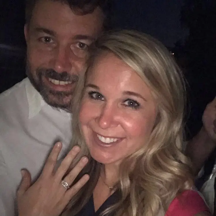 happy couple showing off engagement ring