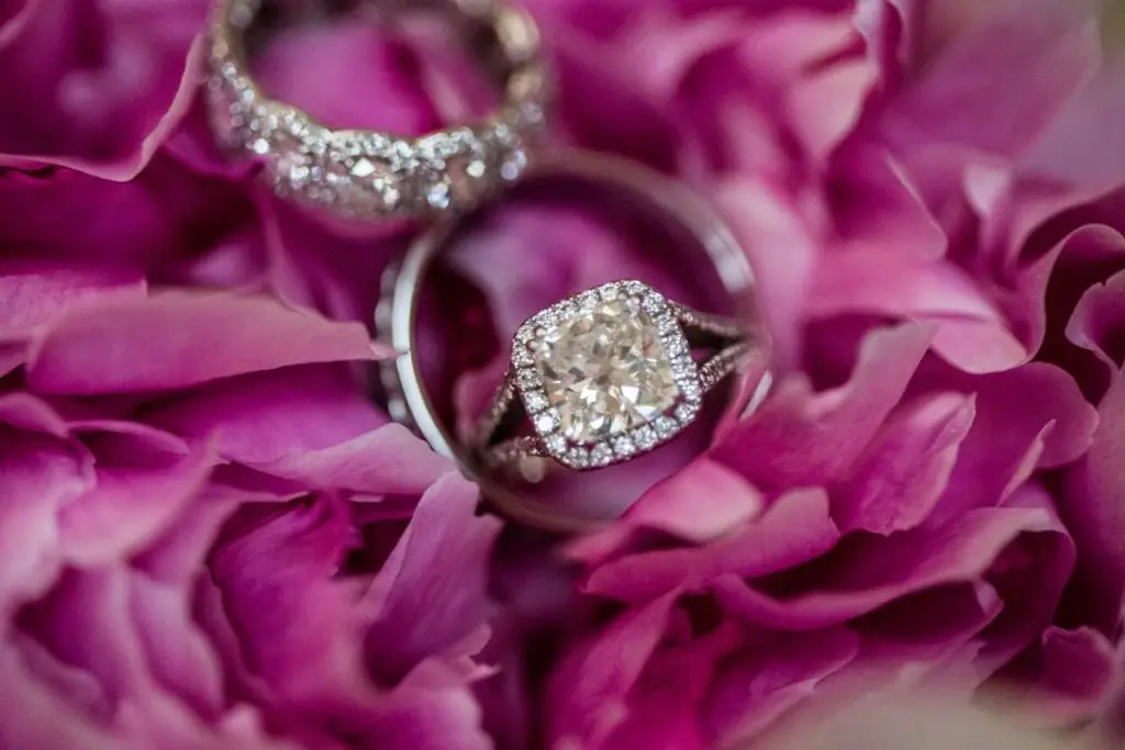 diamond ring set placed on top of pink flowers