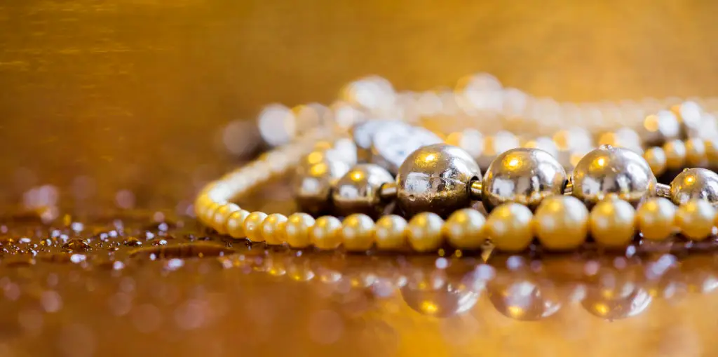 pearl necklace strands laying on a counter