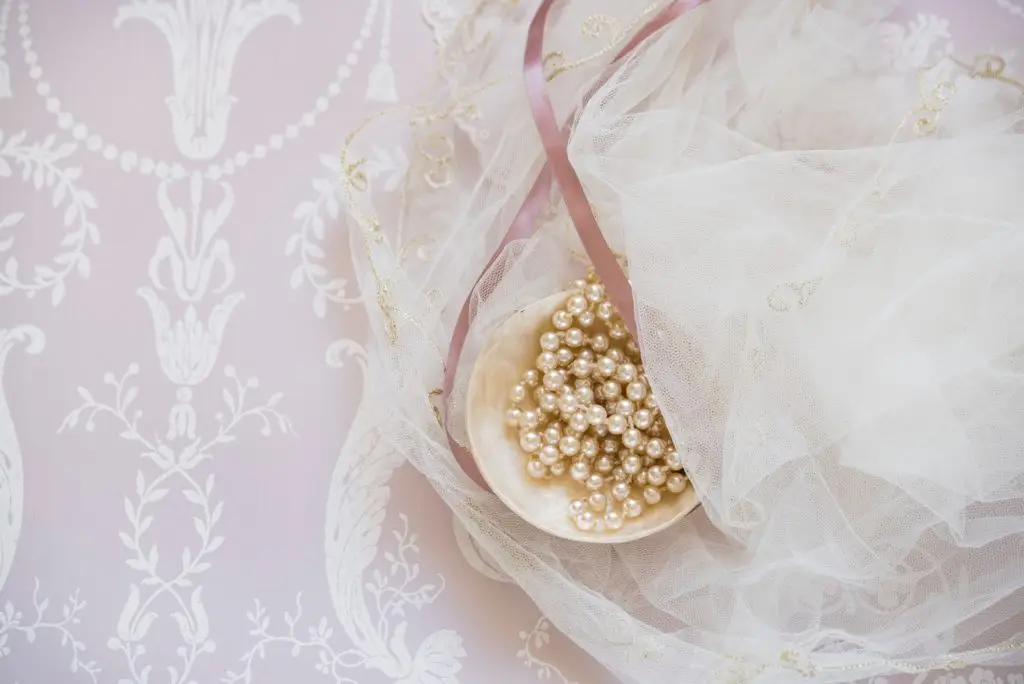 previous pearl necklaces laying on a wedding veil