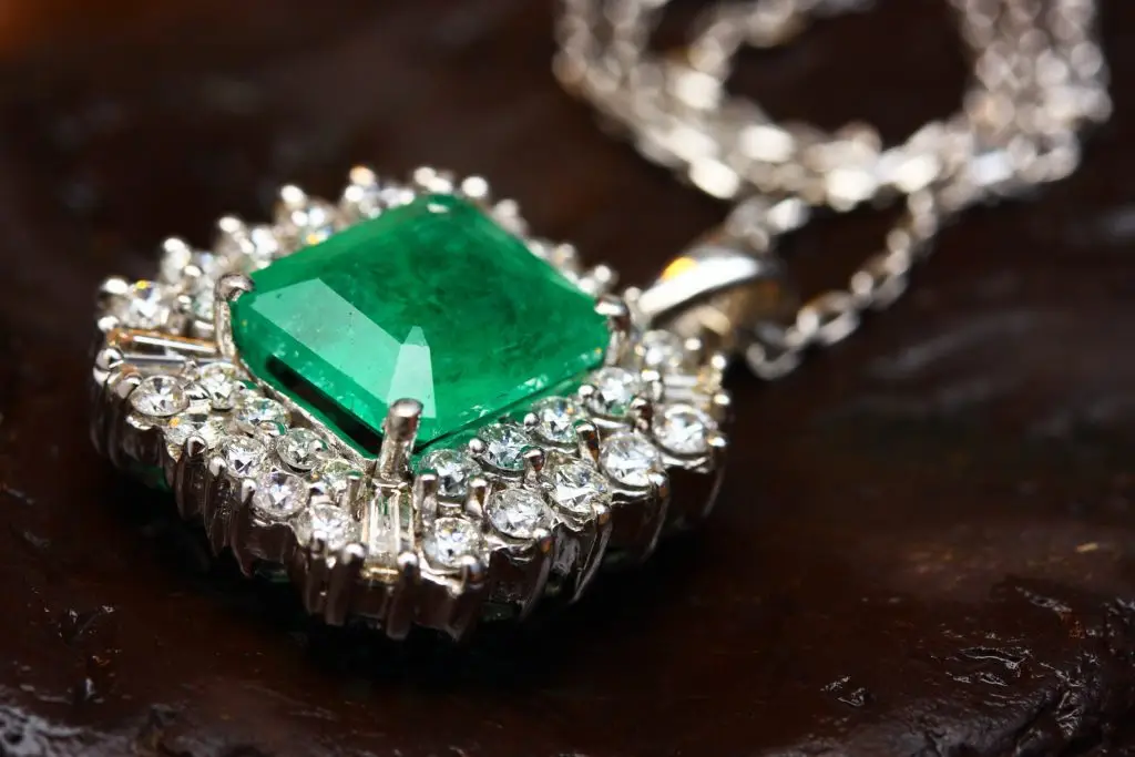 emerald and diamond pendant on a silver chain