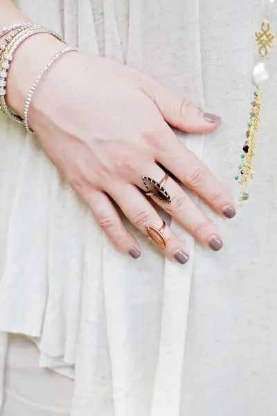 smokey quartz ring on woman's middle finger