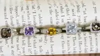 different birthstone rings in a line