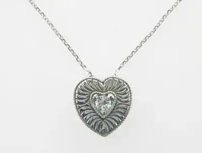 heart shaped pendant with a diamond in the middle