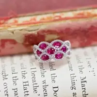 ruby and diamond dinner ring placed on top of an open book