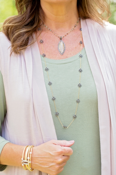 woman wearing silver and gold plated medallion necklace