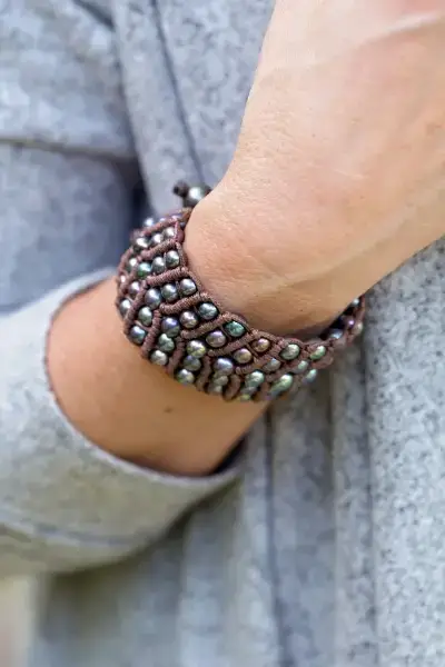 grey pearl leather cuff on a woman's wrist