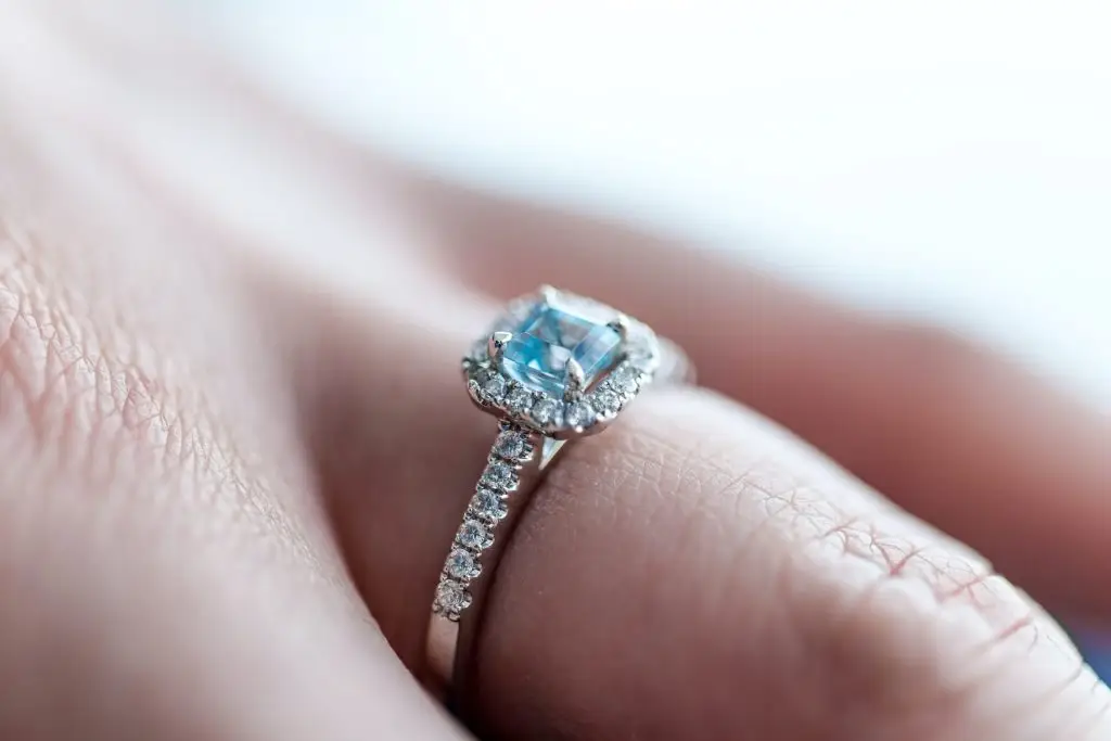 march birthstone the aquamarine and diamond ring on a woman's finger