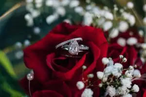 a pear cut diamond ring and band styled in a red rose