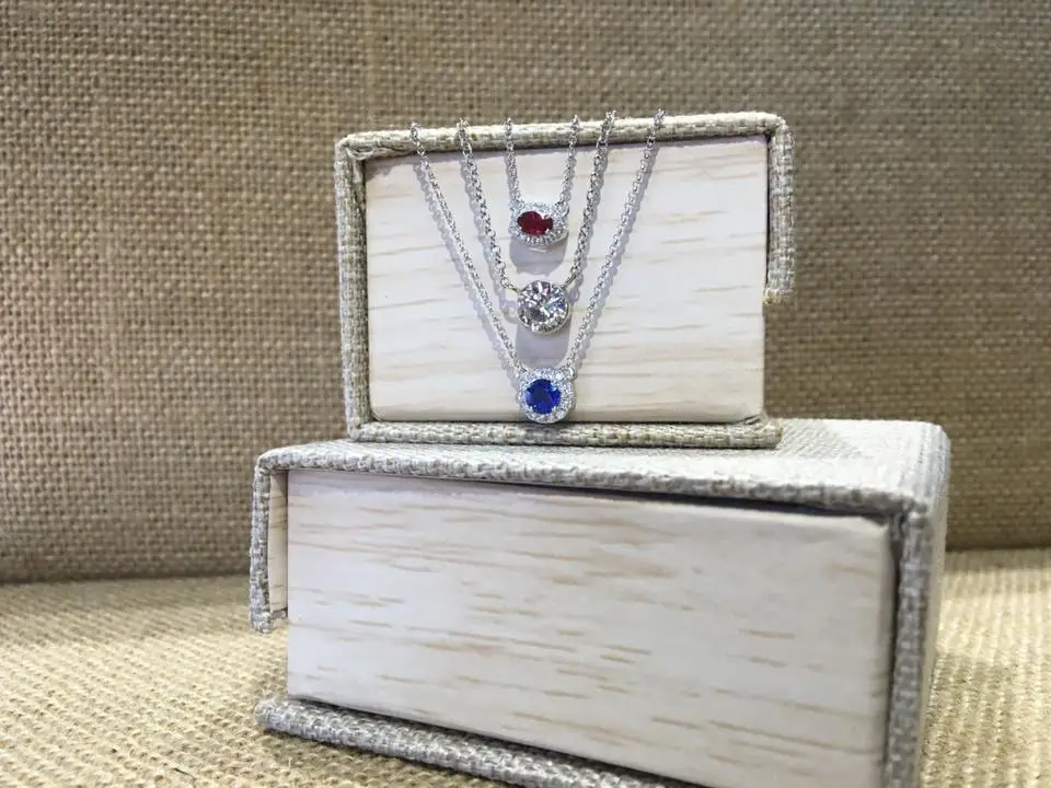 patriotic jewelry with red, white, and blue gemstones hanging off the side of a jewelry box