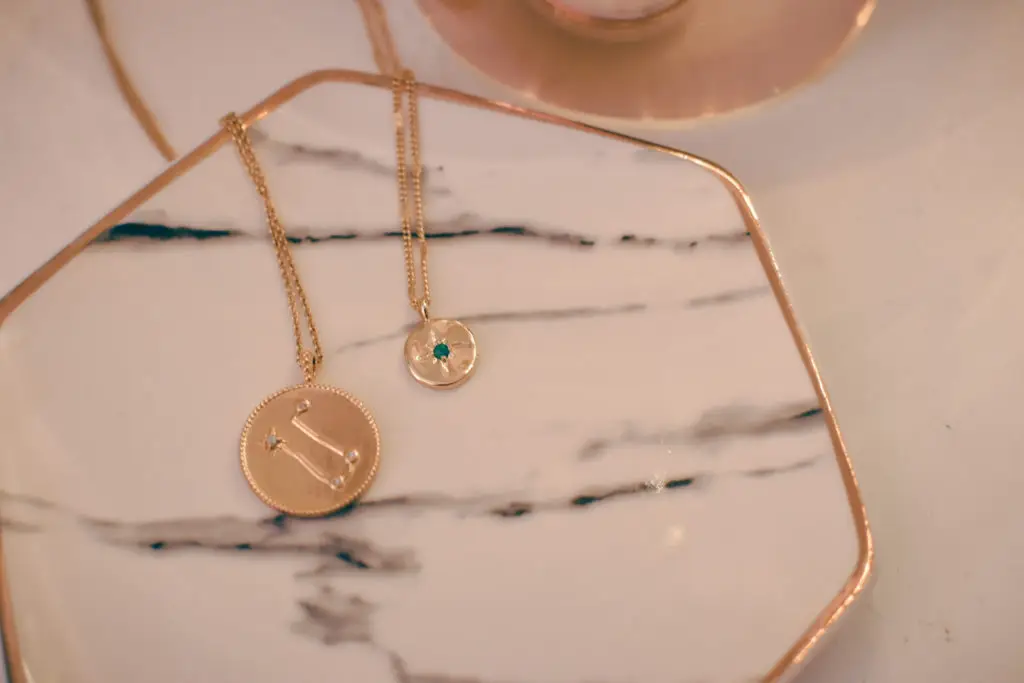 bold gold jewelry displayed on a marble dish