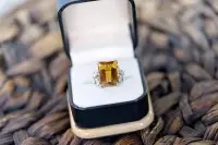 Citrine ring with emerald cut set in platinum in a black box