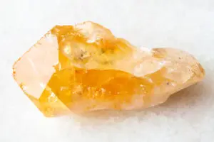 rough Citrine gemstone on a white background