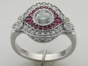 double halo ruby gemstone and custom-designed diamond ring on a white background