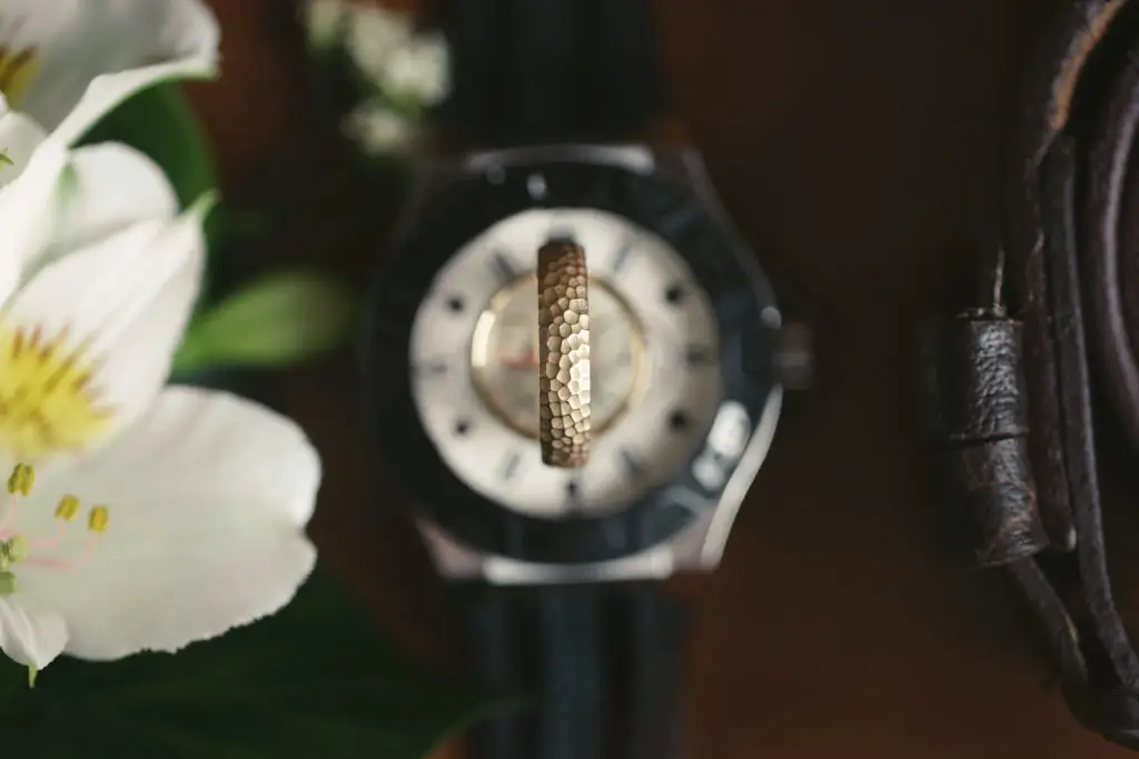 jewelry gifts for men sitting next to a white flower