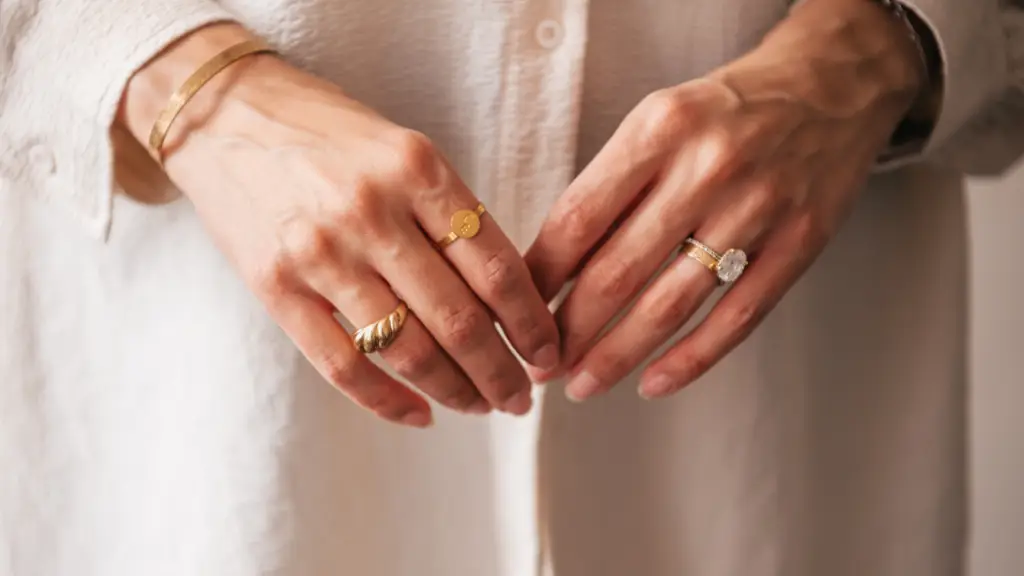 A woman's hands with rings and bracelets on them