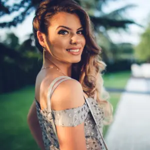 Girl turned to the side in her prom dress with long earrings on