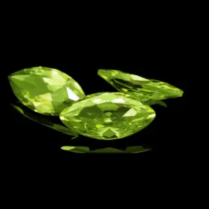 bright green peridot gemstones with a black background