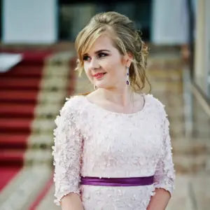 teenage girl in her violet lace prom dress wearing diamond and amethyst earrings