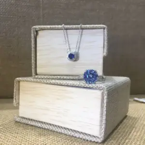 A blue sapphire and diamond pendant necklace with a blue sapphire ring