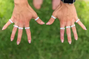 Woman's hands wearing the Casual Carats diamond silicone rings on each finger in white