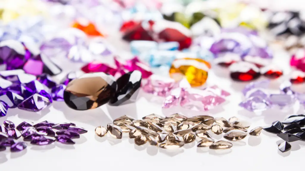 Colored gemstones arranged on a white table