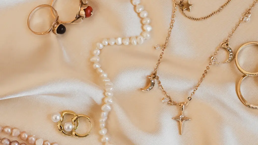 A collection of pearl necklaces, rings and gold chains as part of a capsule jewelry collection