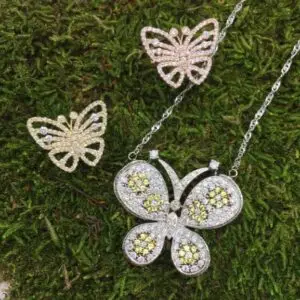 A butterfly shaped pendant filled with yellow diamonds and white diamonds