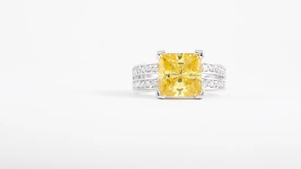 A canary yellow diamond ring on a white background