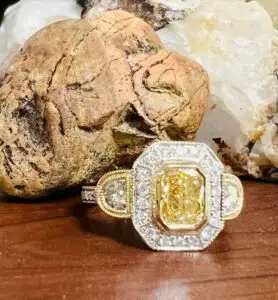 a custom designed yellow diamond ring with white and yellow gold