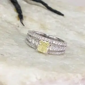 yellow diamond wedding bands sitting on a table