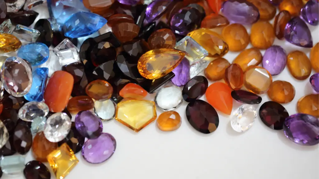 orange purple and brown fall gemstones scattered on a white background