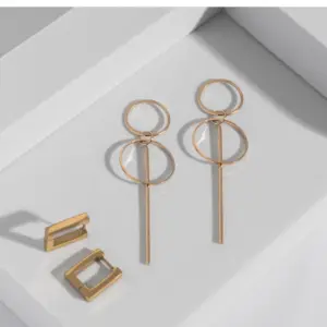 A pair of yellow gold square shaped hoop earrings and a pair of gold circular earrings with a long bar on a white background