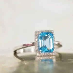 A blue topaz ring surrounded by diamonds