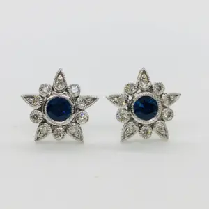 Blue sapphire gemstone earrings with diamonds in a star shape