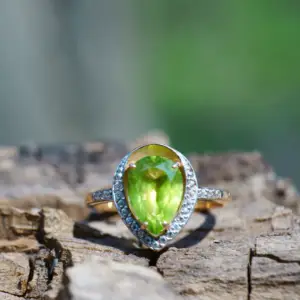 A cats eye gemstone ring in a green hue cut in a pear shape