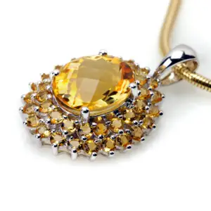 A large imperial topaz gemstone pendant necklace on a white background