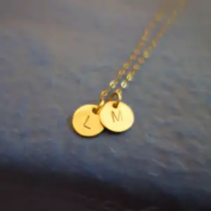 Gold pendants with alphabet initials engraved on them