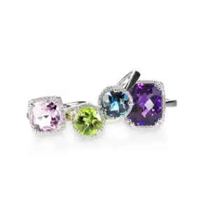 a collection of birthstone rings in different colors on a white background