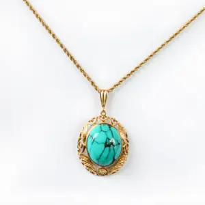 A turquoise cabochon cut pendant necklace on a white background